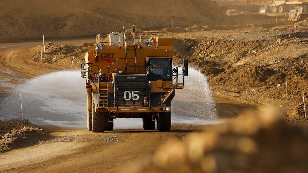 Mining truck spraying water for dust control
